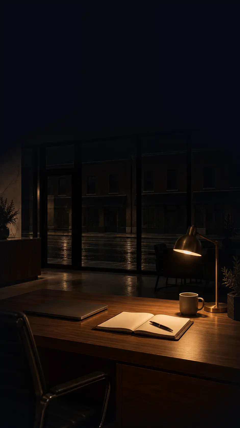 A broker’s desk after hours, a lamp over an open notebook and a laptop